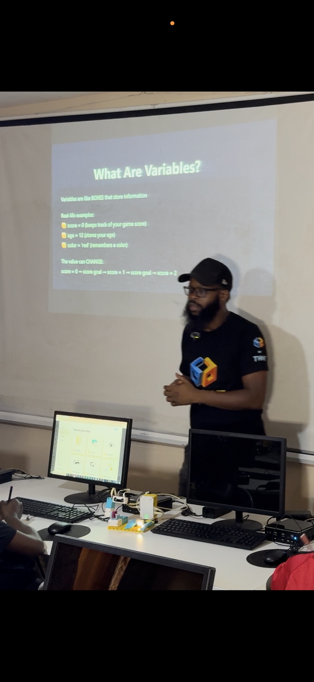 Abdul Malik Jalloh leading a classroom lesson with LEGO equipment on the workbench